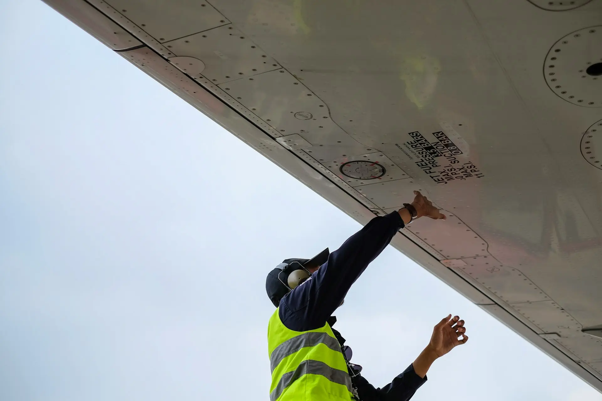 Technician inspecting and maintaining signage for durability and functionality.