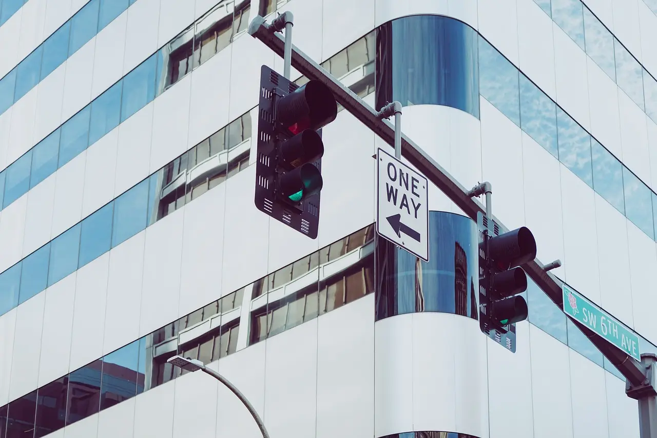 Directional signage on a modern office building, assisting with navigation.