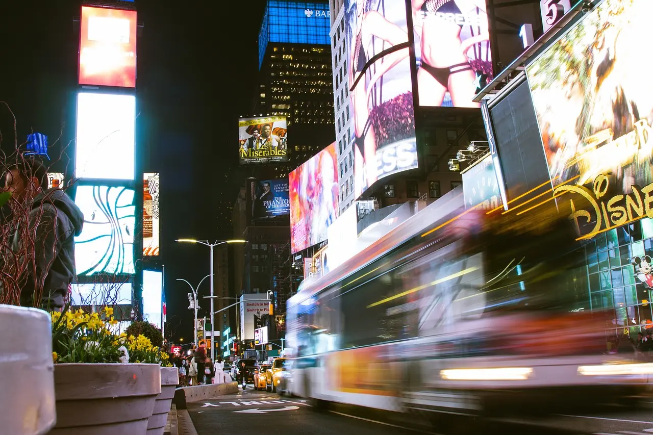 Bright digital signage displaying advertisements in a bustling cityscape.