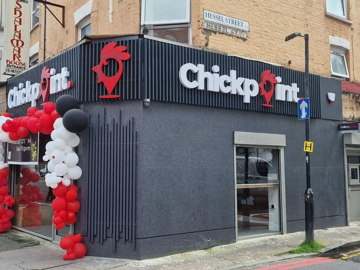 Promotional signage for Chickpoint featuring vibrant storefront branding