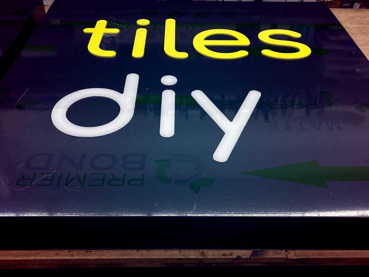 Tiles DIY illuminated signage under fabrication in the workshop.