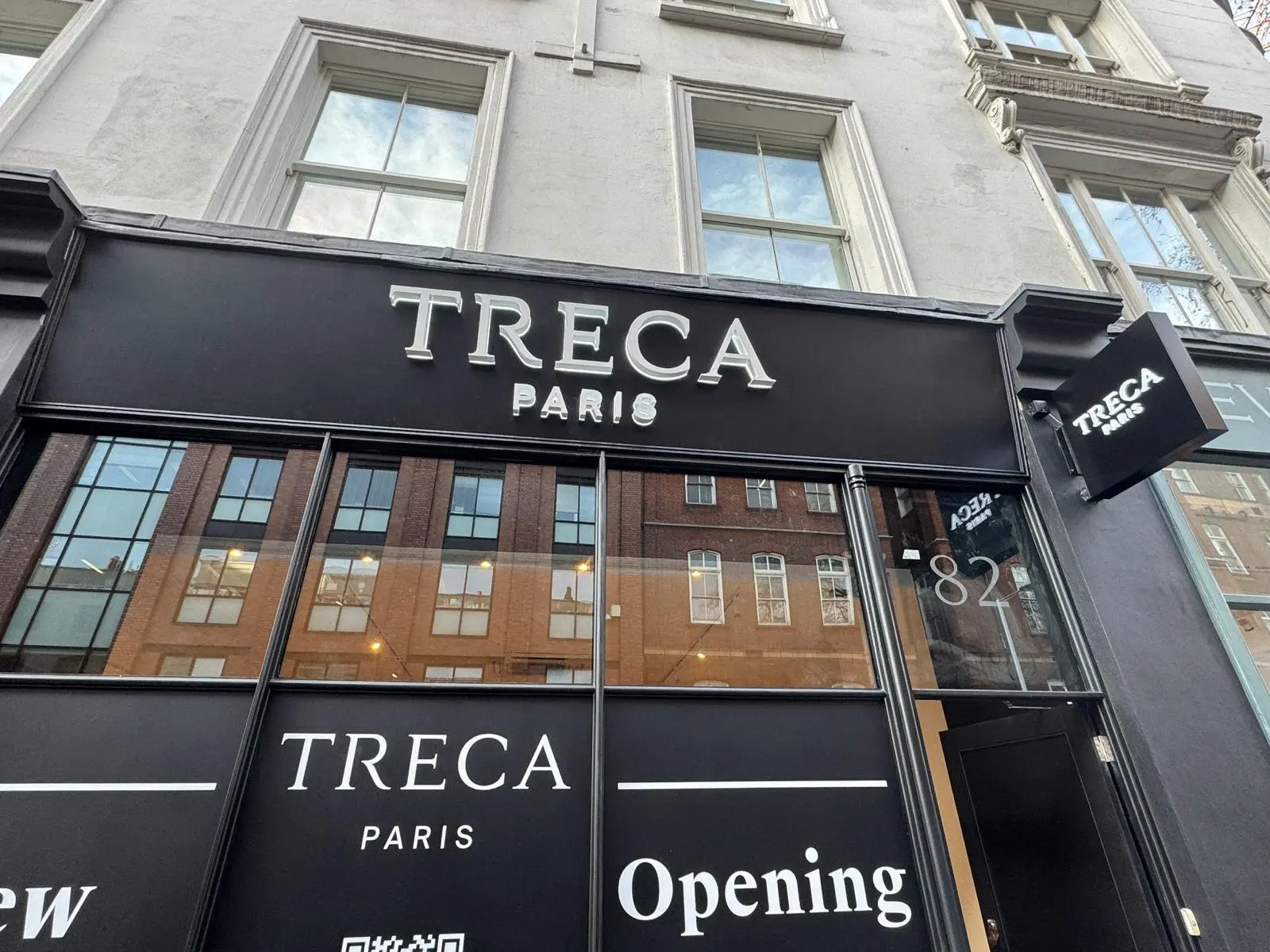 TRECA Paris storefront with custom window and wall graphics by Sign Architects