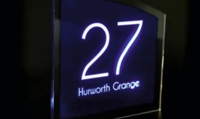 Illuminated acrylic door number plaque for a modern business.