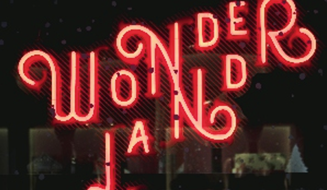 Bright red neon-illuminated Wonderland sign at night.