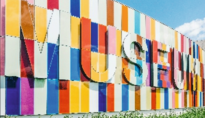 Colourful flat cut letter signage on a modern building exterior.