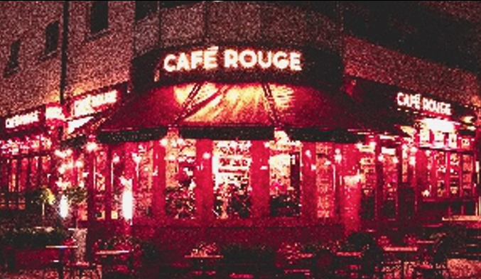 Illuminated face signage of Cafe Rouge at night.