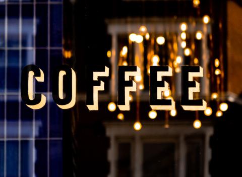 Stylish illuminated coffee shop signage, boosting visibility at night.